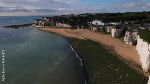 Drone aerial shot of Empty Kingsgate Beach and Castle on the cliffs above the Bay, on cloudy autumn morning. photo