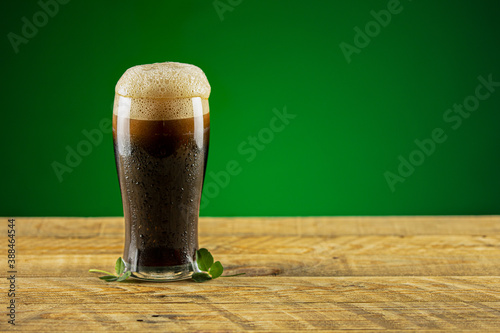 Dark beer on a wooden table photo