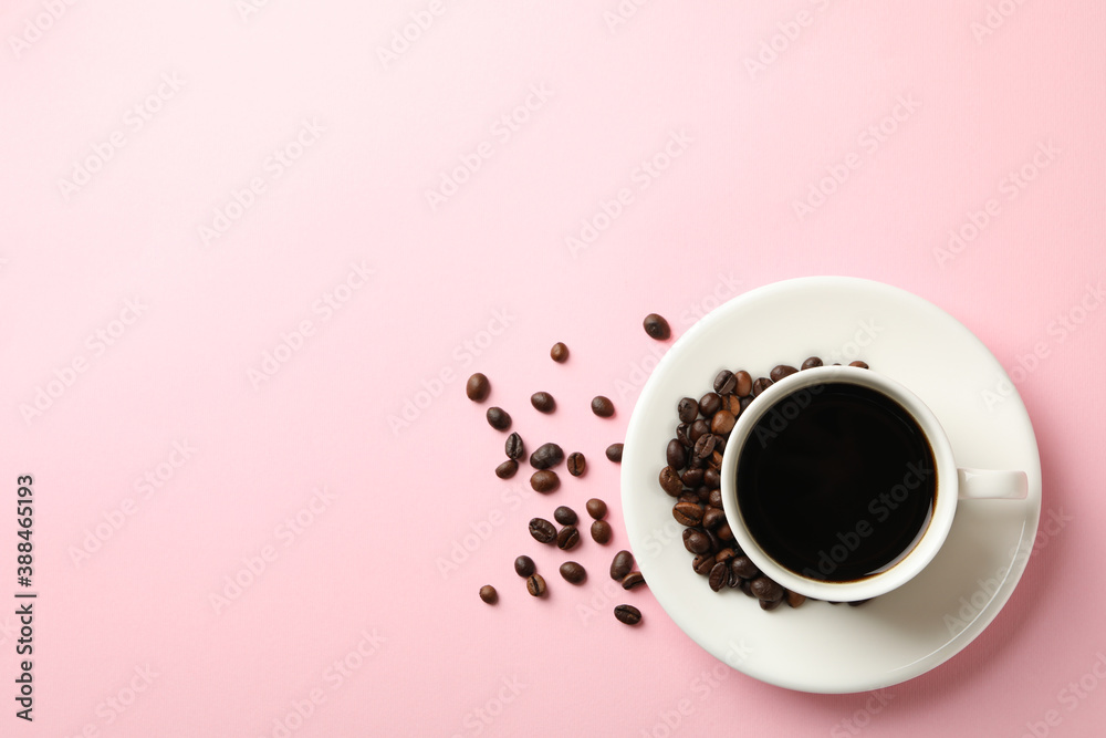 Cup of coffee and beans on pink background Cup of coffee and beans on pink background