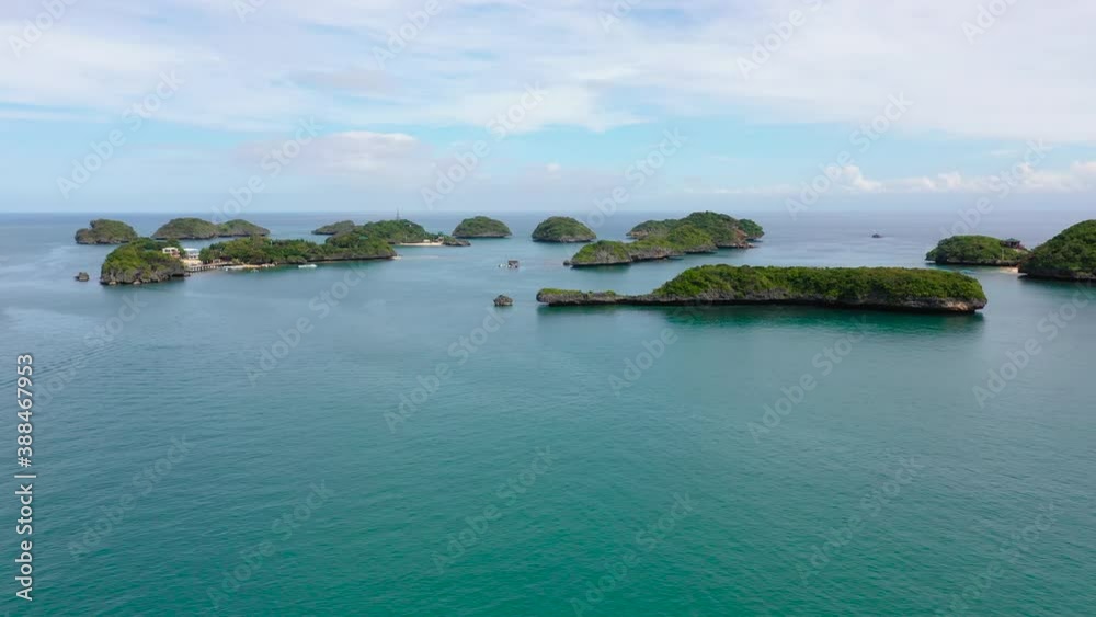 Tropical landscape of the Island with beaches and coves in the turquoise waters in the national Park hundred Islands, Pangasinan, Philippines. Tropical landscape of the Island with beaches and coves in the turquoise waters in the national Park hundred Islands, Pangasinan, Philippines.