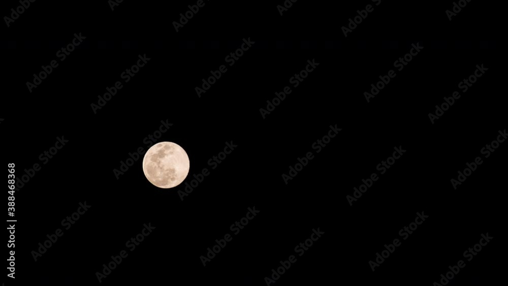 Timelapse of full moon rising in dark sky, isolated on black background Timelapse of full moon rising in dark sky, isolated on black background