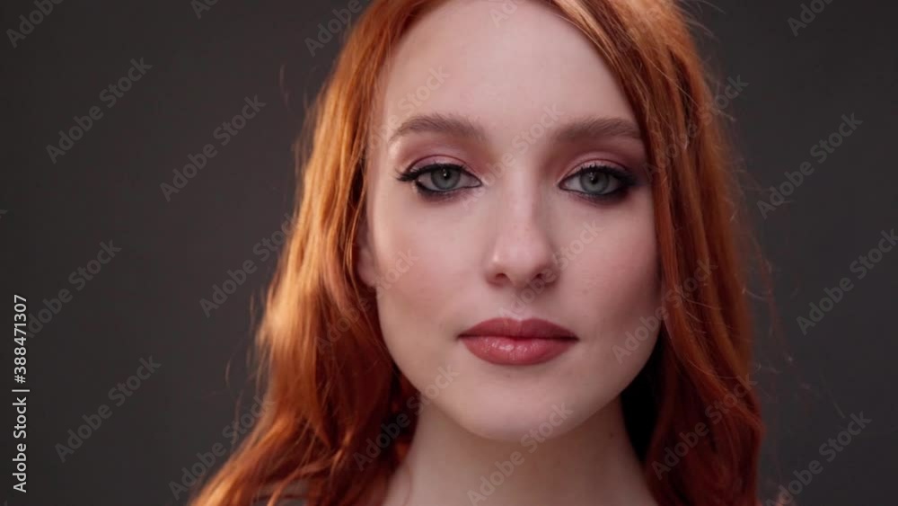 Red-haired woman 25-30 years old face close-up. Calm facial expression. Advertising of skin care products. Expression wrinkles. Shots under the eyes. Aging makeup. Red-haired woman 25-30 years old face close-up. Calm facial expression. Advertising of skin care products. Expression wrinkles. Shots under the eyes. Aging makeup.