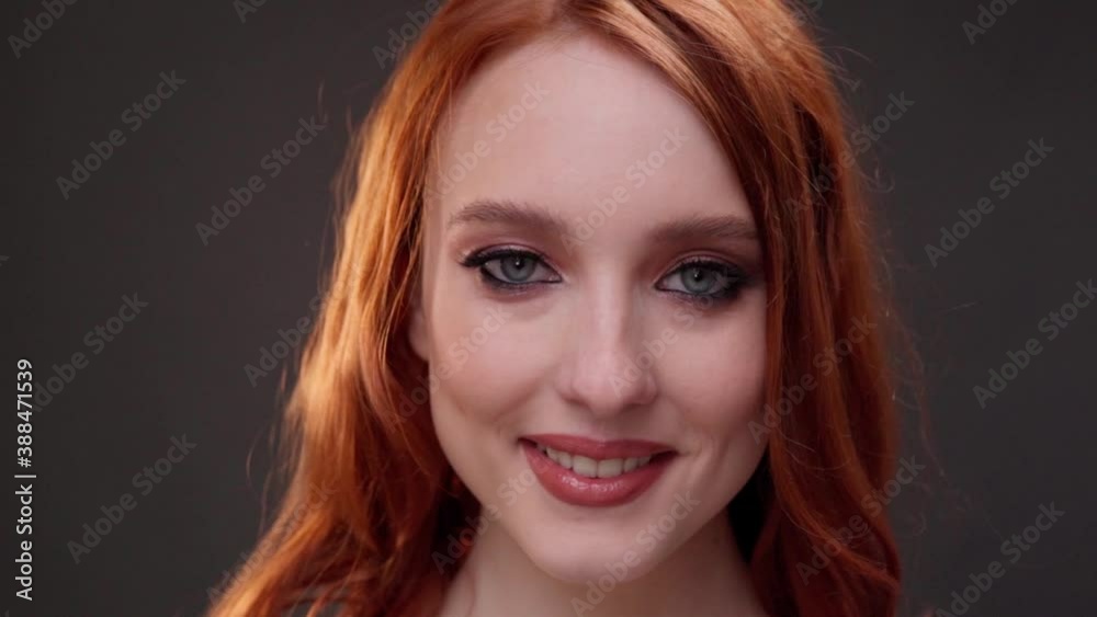 Red-haired woman 25-30 years old face close-up. Smile with teeth. Advertising of skin care products. Expression wrinkles. Shots under the eyes. Aging makeup. Red-haired woman 25-30 years old face close-up. Smile with teeth. Advertising of skin care products. Expression wrinkles. Shots under the eyes. Aging makeup.