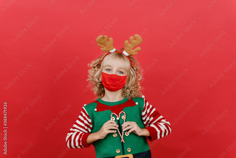 Merry Christmas on quarantine coronavirus pandemic. Little girl with