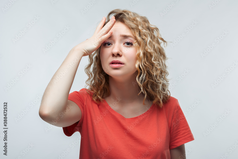 Pretty blonde girl in casual t shirt Made A Mistake. Pensive concept. Studio shot, white background Pretty blonde girl in casual t shirt Made A Mistake. Pensive concept. Studio shot, white background
