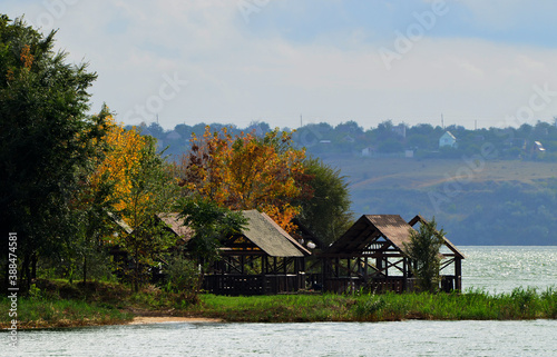 Autumn nature, wooden tents at the river, rest photo