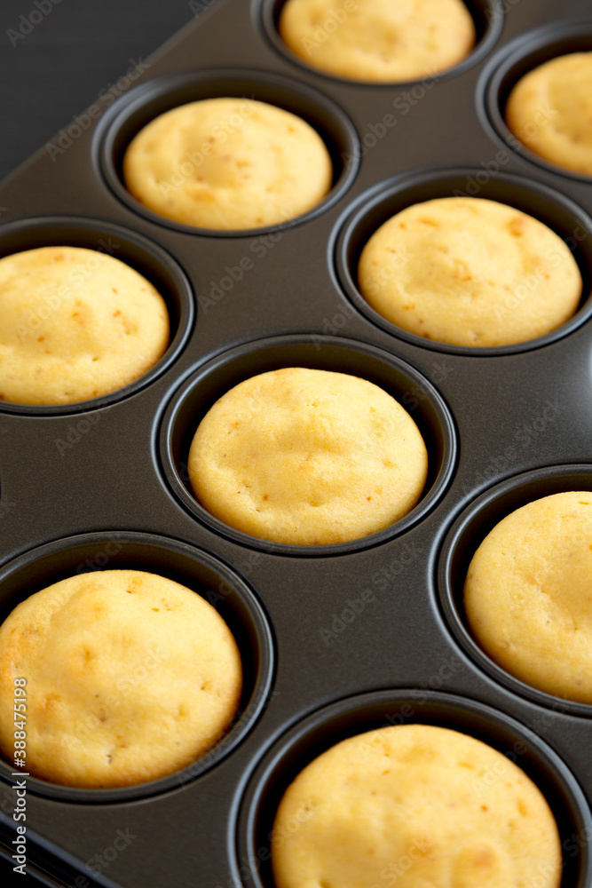 Homemade Cornbread Muffins on a black background, low angle view. Close-up. Homemade Cornbread Muffins on a black background, low angle view. Close-up.