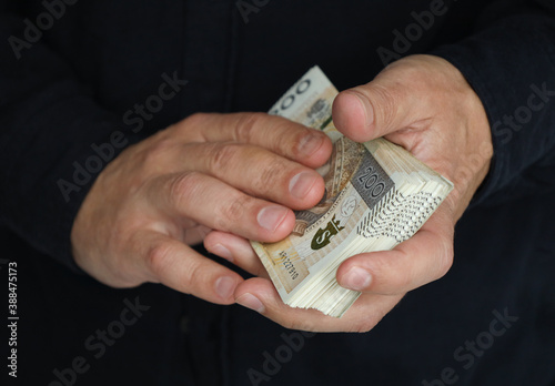 stack of large banknotes in the hands of a man. selective focus