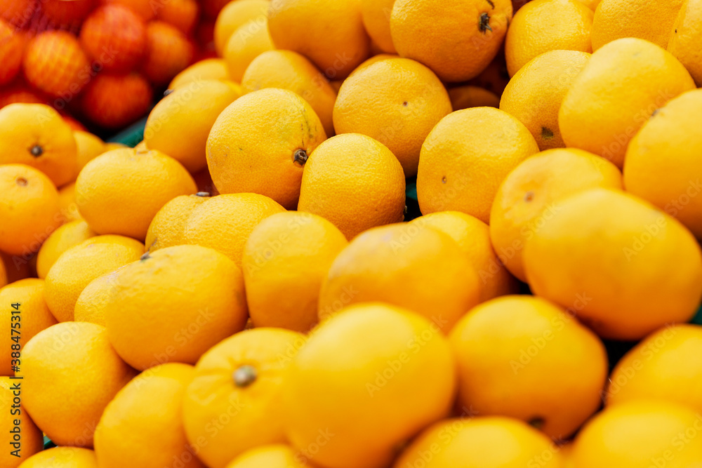 Lots of ripe tangerines on the counter in the store. Close-up. Lots of ripe tangerines on the counter in the store. Close-up.