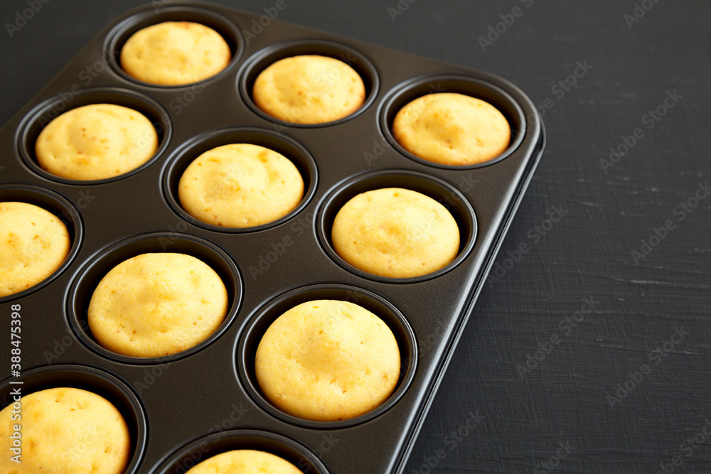 Homemade Cornbread Muffins on a black background, side view. Copy space. Homemade Cornbread Muffins on a black background, side view. Copy space.