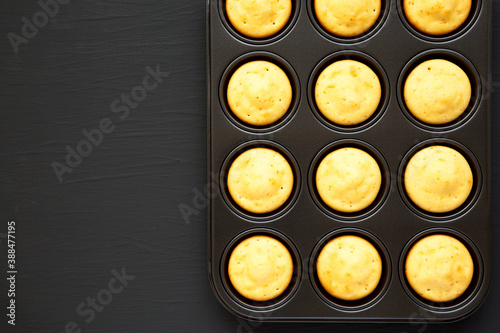 Homemade Cornbread Muffins on a black background, top view. Flat lay, overhead, from above. Copy space.