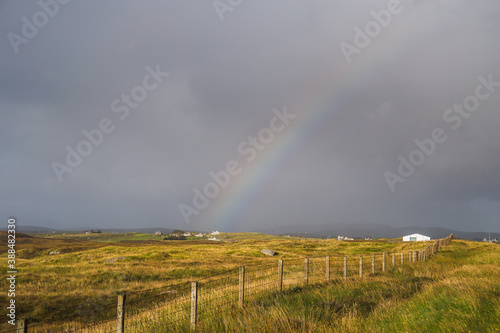 Dark skies and colourful rainbow over the hills of South Uist, Outer Hebrides, Scotland