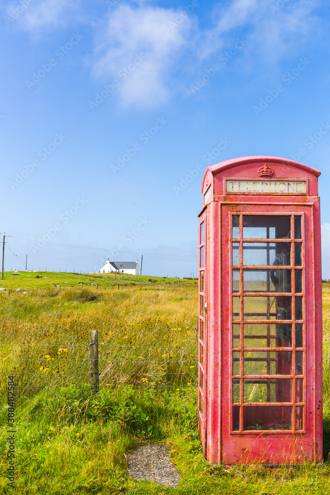 Red telephone box and crofters houses at North Uist, Outer Hebrides, Scotland Red telephone box and crofters houses at North Uist, Outer Hebrides, Scotland