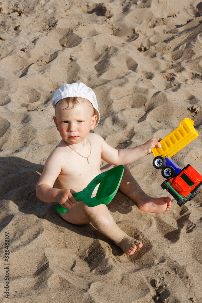 child playing on the beach by the water child playing on the beach by the water