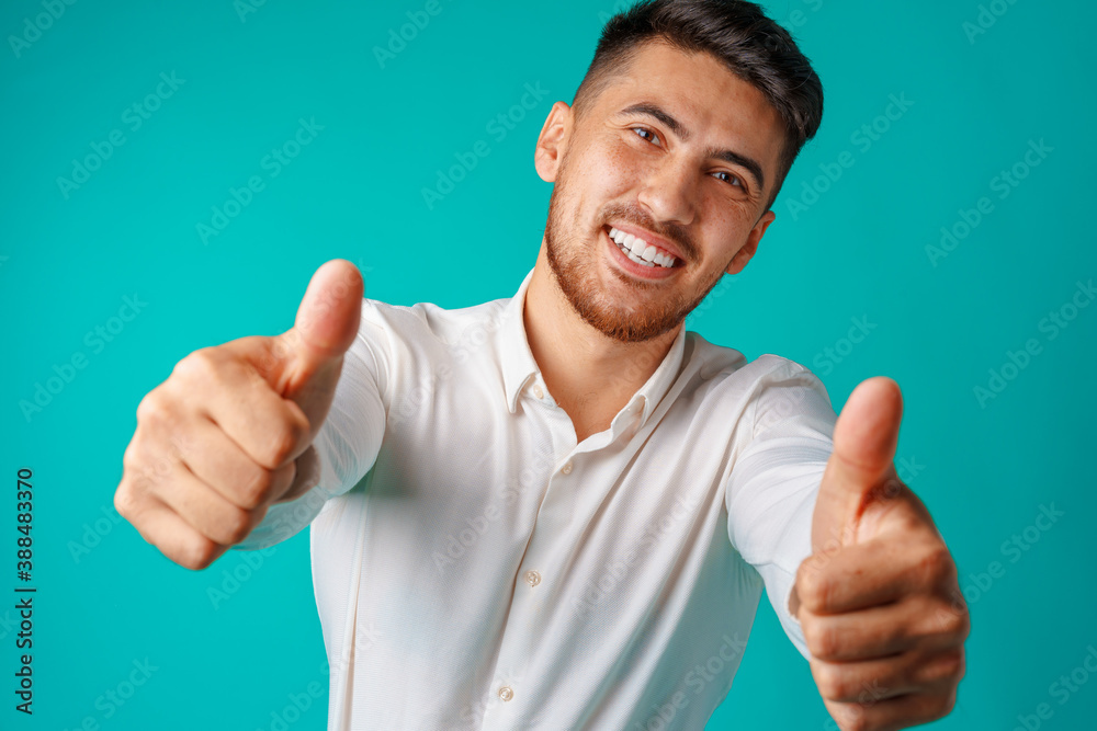Positive handsome hispanic businessman showing thumb up gesture - obrazy, fototapety, plakaty 