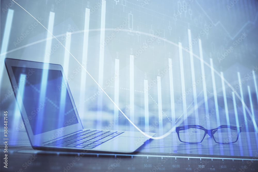 Forex graph hologram on table with computer background. Multi exposure. Concept of financial markets. Forex graph hologram on table with computer background. Multi exposure. Concept of financial markets.