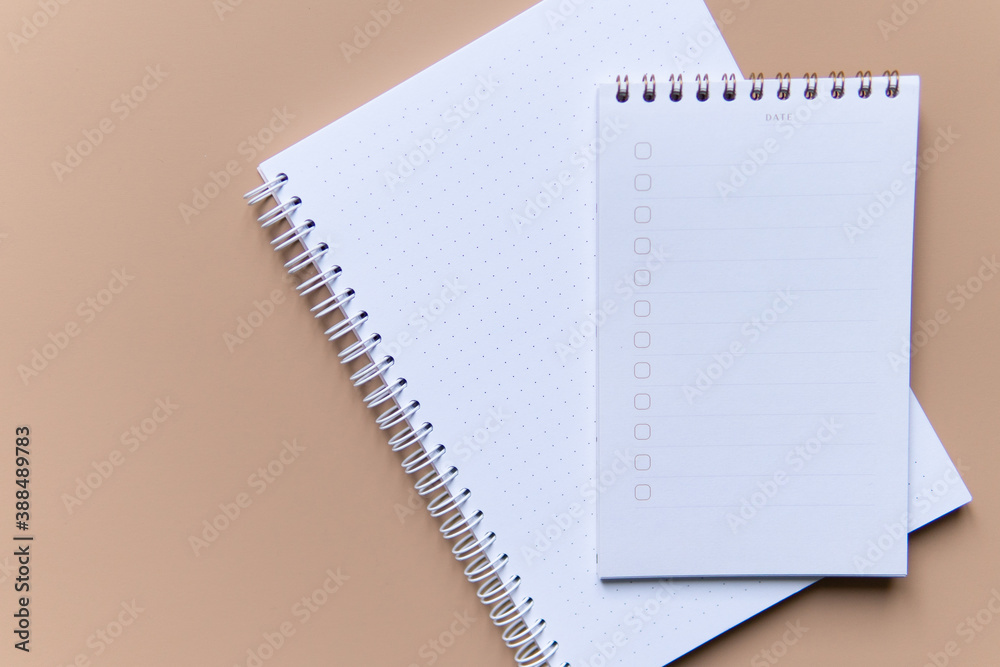 business composition with notebooks and pens on a brown background with a place for writing.