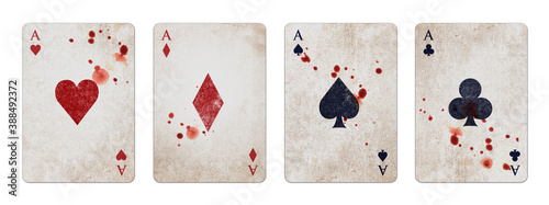 Poker card aces on aged vintage background, splattered with blood, isolated on white background photo