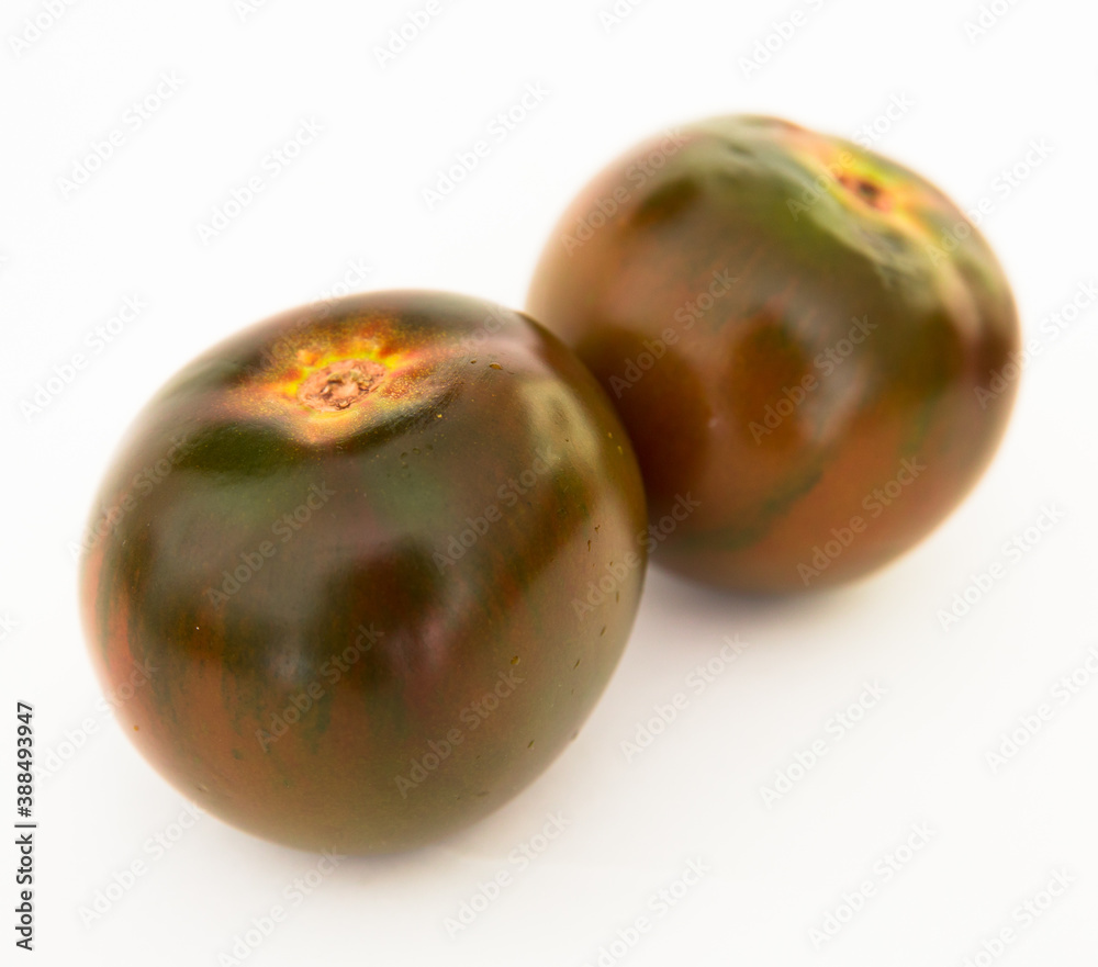 ripe black tomatoes on a white background ripe black tomatoes on a white background
