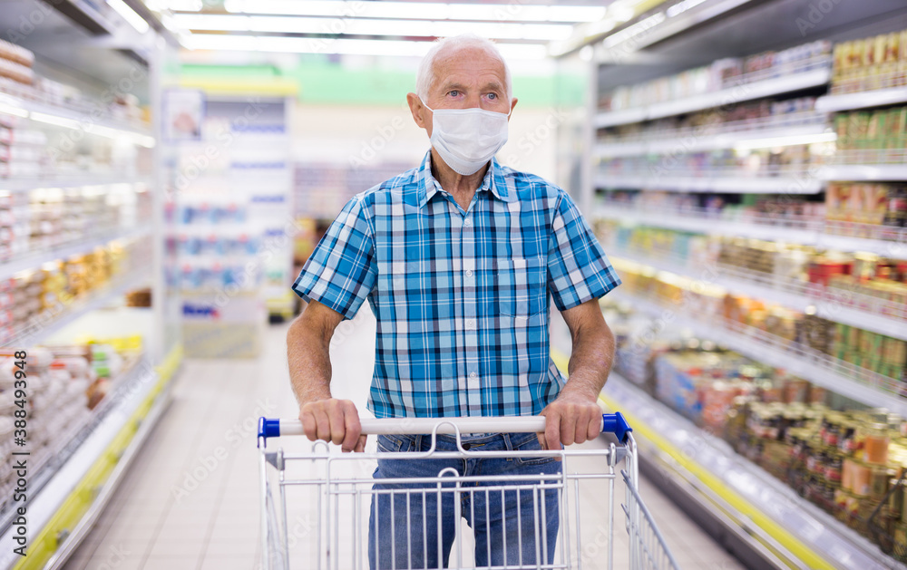 older european man wearing mask and gloves with covid protection shoping in supermarket older european man wearing mask and gloves with covid protection shoping in supermarket