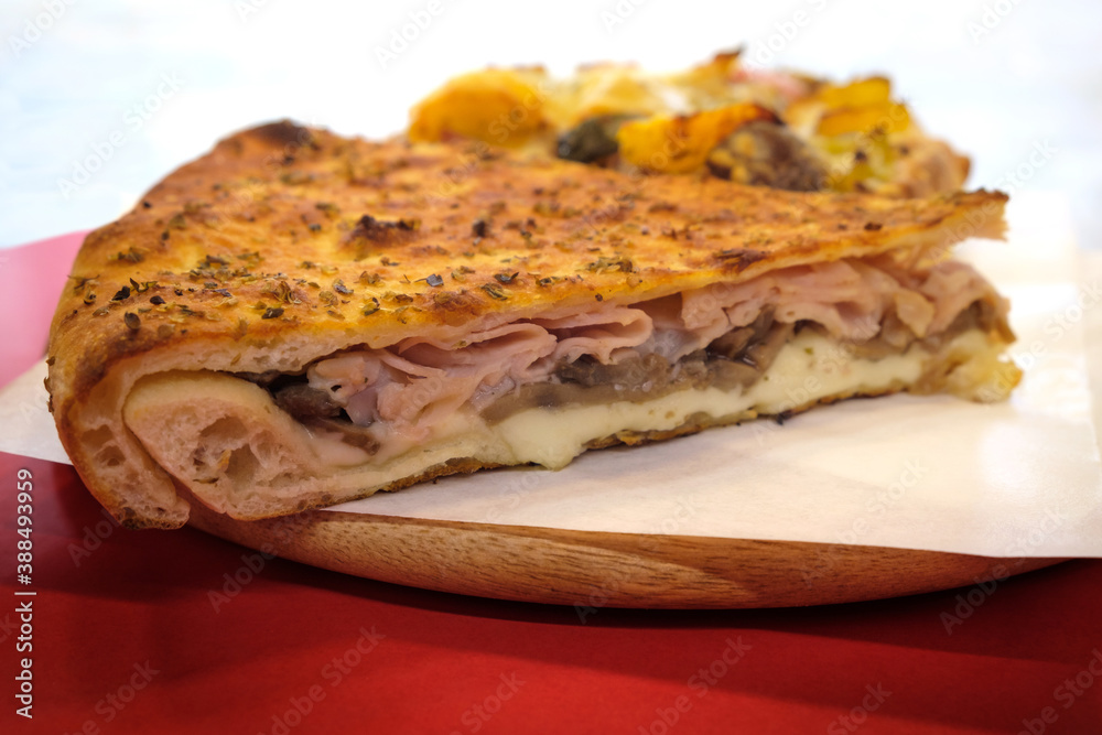 Fast food pizza slice filled with ham cheese and mushrooms 