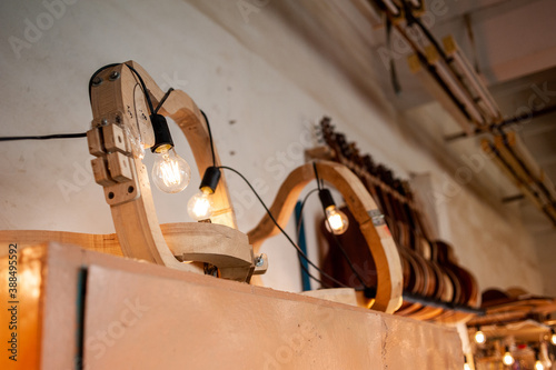 Parts of guitar hanging on the shelves at the factory photo