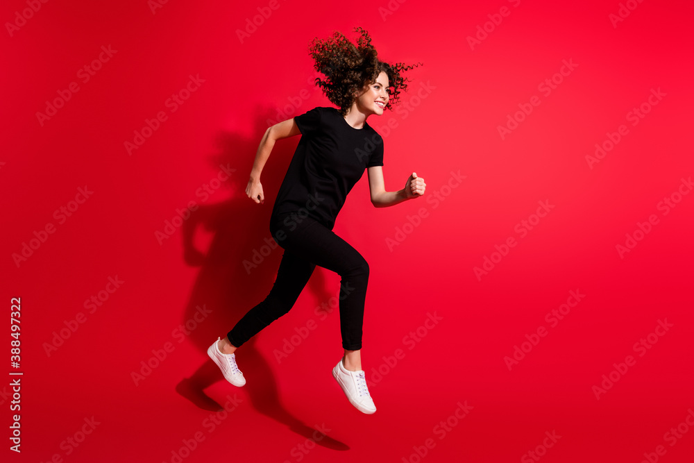 Photo portrait full body view of girl running jumping up isolated on vivid red colored background