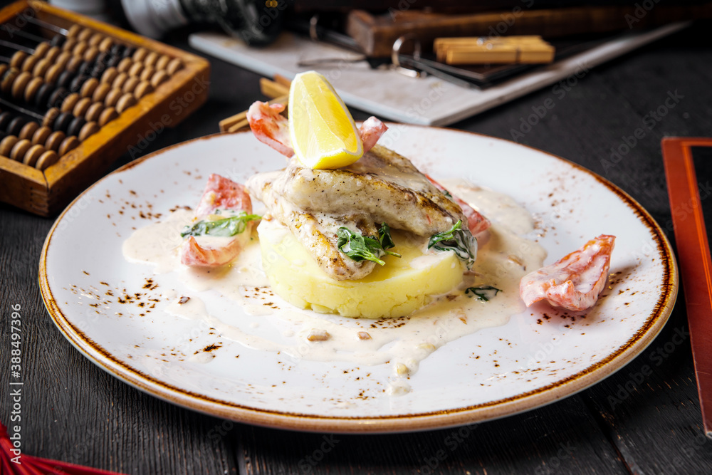 Gourmet cooked white fish fillet on mashed potato