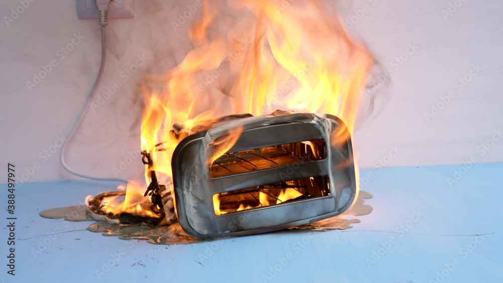 Toaster on fire. Household electrical appliance fire hazard. Overload