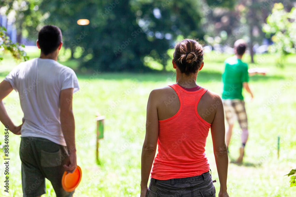 Fototapeta premium People playing flying disc sport game in the park or nature