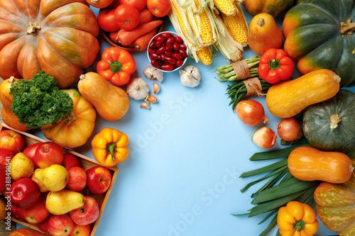 Pumpkins  apples and bell pepper composition on blue background