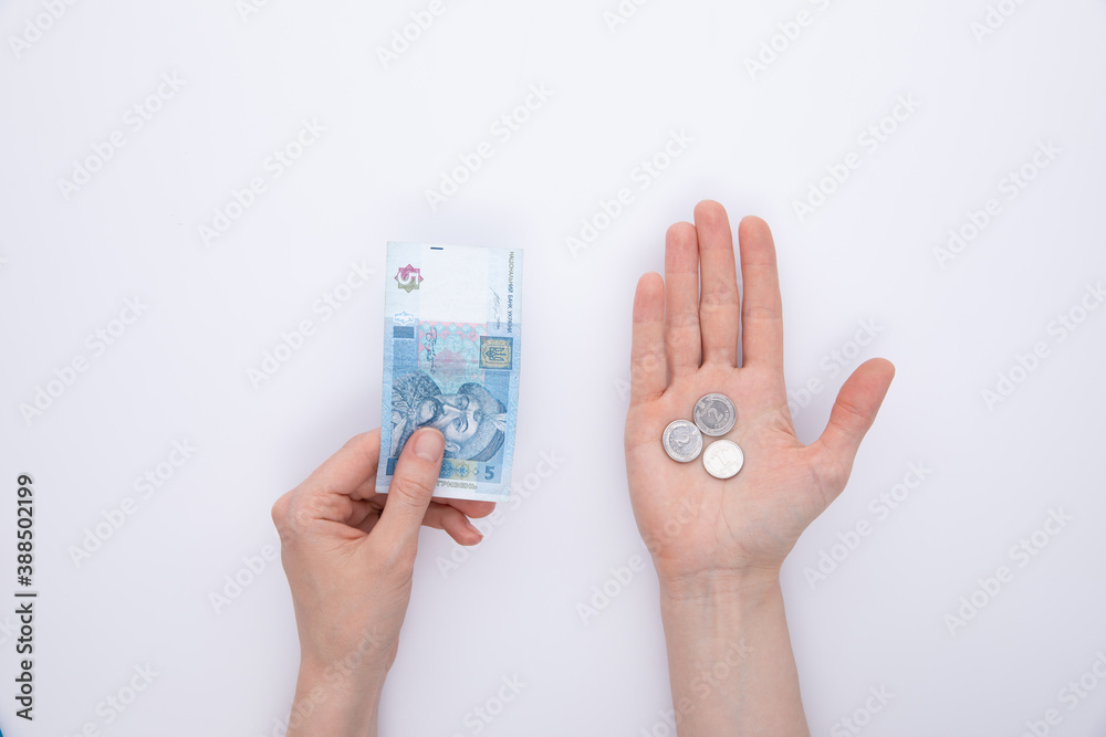 female hands with coins and hryvnia, top view female hands with coins and hryvnia, top view