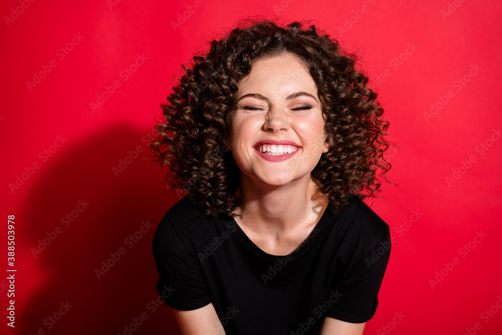 Close-up portrait of charming glad cheerful wavy-haired girl laughing grinning teeth isolated over bright red color background Close-up portrait of charming glad cheerful wavy-haired girl laughing grinning teeth isolated over bright red color background