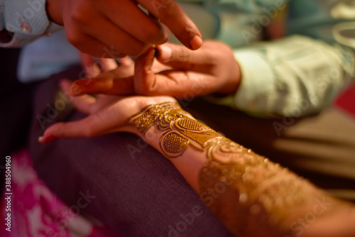 Henna is applied to the hands of a beautiful Hindu Bride on her wedding.