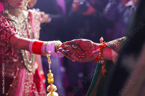 Indian marriage couple hand in hand for ritual on their wedding