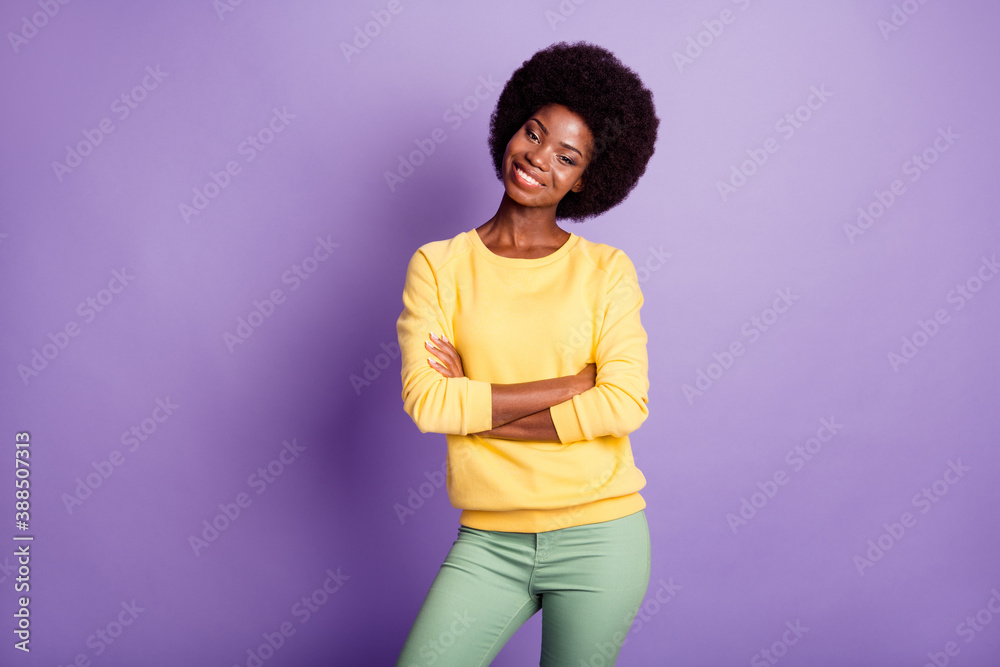 Photo of charming dark skin girl cross hands wear green trousers isolated over purple color background Photo of charming dark skin girl cross hands wear green trousers isolated over purple color background