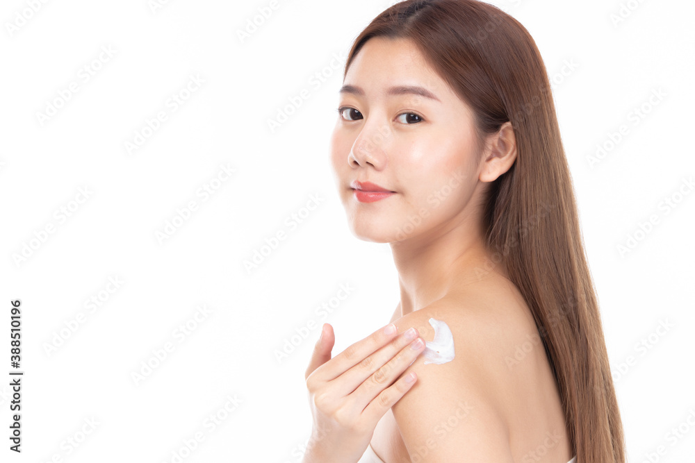 Attractive young Asian woman applying body cream and smiling while standing on white background. Attractive young Asian woman applying body cream and smiling while standing on white background.
