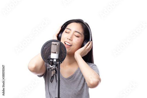 Young asian woman with microphone recording song in music studio happy expression face isolated on white background.