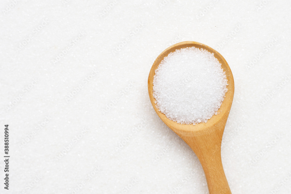 Wooden spoon with white granulated sugar. Top view Wooden spoon with white granulated sugar. Top view