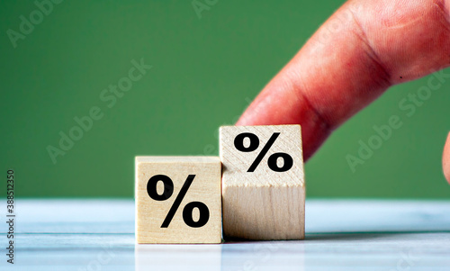 Hand turn wood cube block with percentage symbol icon. Interest rate, financial, ranking and mortgage concept