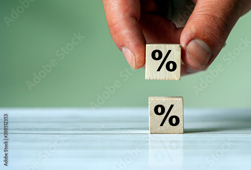 Hand turn wood cube block with percentage symbol icon. Interest rate, financial, ranking and mortgage concept