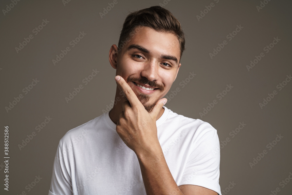 Image of joyful unshaven guy laughing while posing on camera Image of joyful unshaven guy laughing while posing on camera