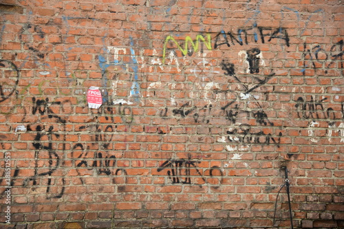Old brick wall with graffiti