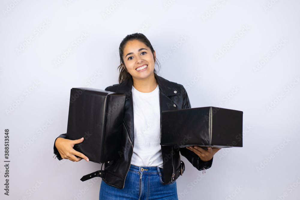 Obraz premium Young beautiful woman holding gifts over isolated smiling and looking at the camera white background