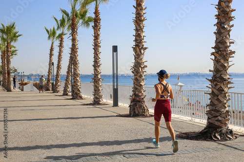 Young woman jogging in the morning at the park in Antalya Turkey.