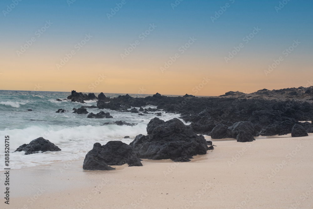 Beach with rocks surrounded by waves