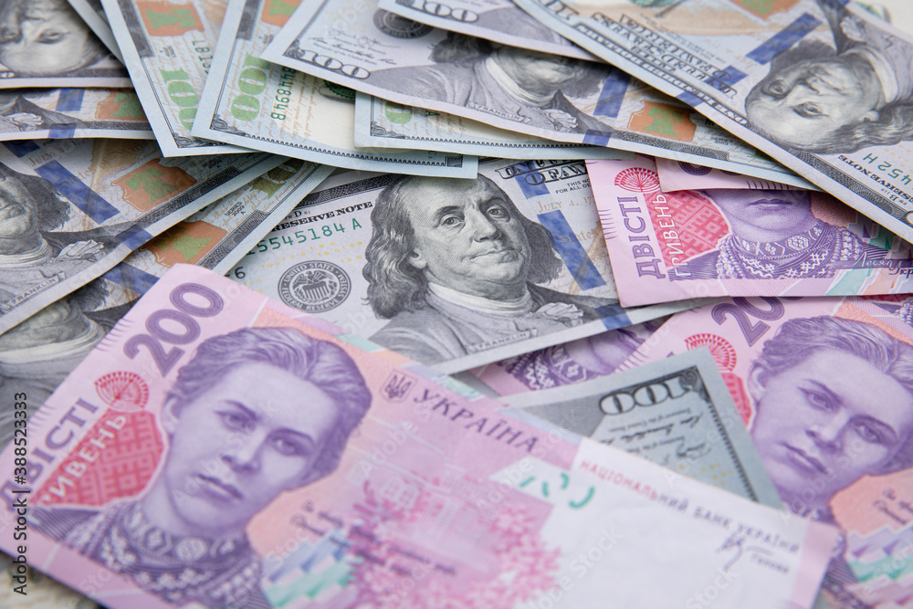 collection of hundred-dollar and two hundred hryvnia banknotes isolated on white background, close view collection of hundred-dollar and two hundred hryvnia banknotes isolated on white background, close view