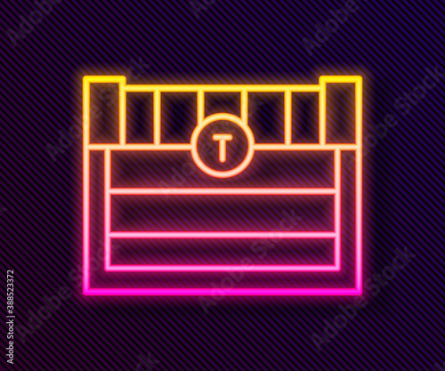 Glowing neon line Antique treasure chest icon isolated on black background. Vintage wooden chest with golden coin. Vector.
