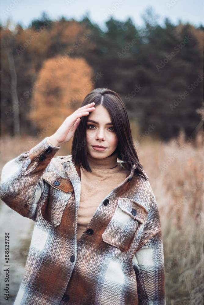 Young woman in a field with dry grass Young woman in a field with dry grass