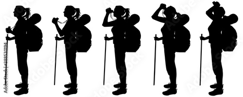 Girl tourist with a large backpack behind back and a walking stick in hand. Woman stands sideways, in profile, and looks through binoculars. Five black female silhouettes isolated on white background.